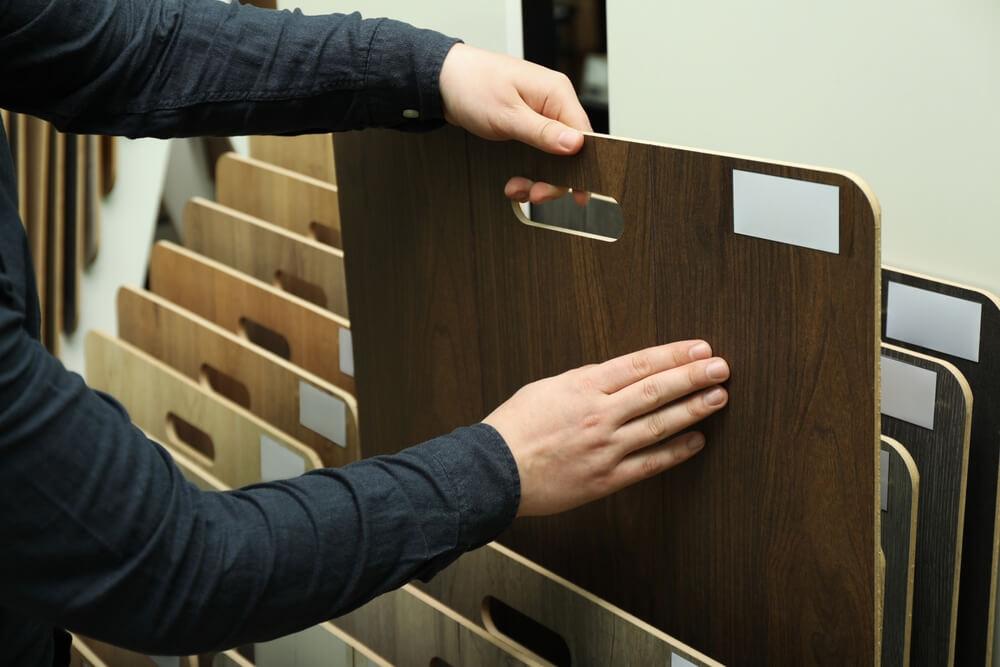 a man is checking plywood quality